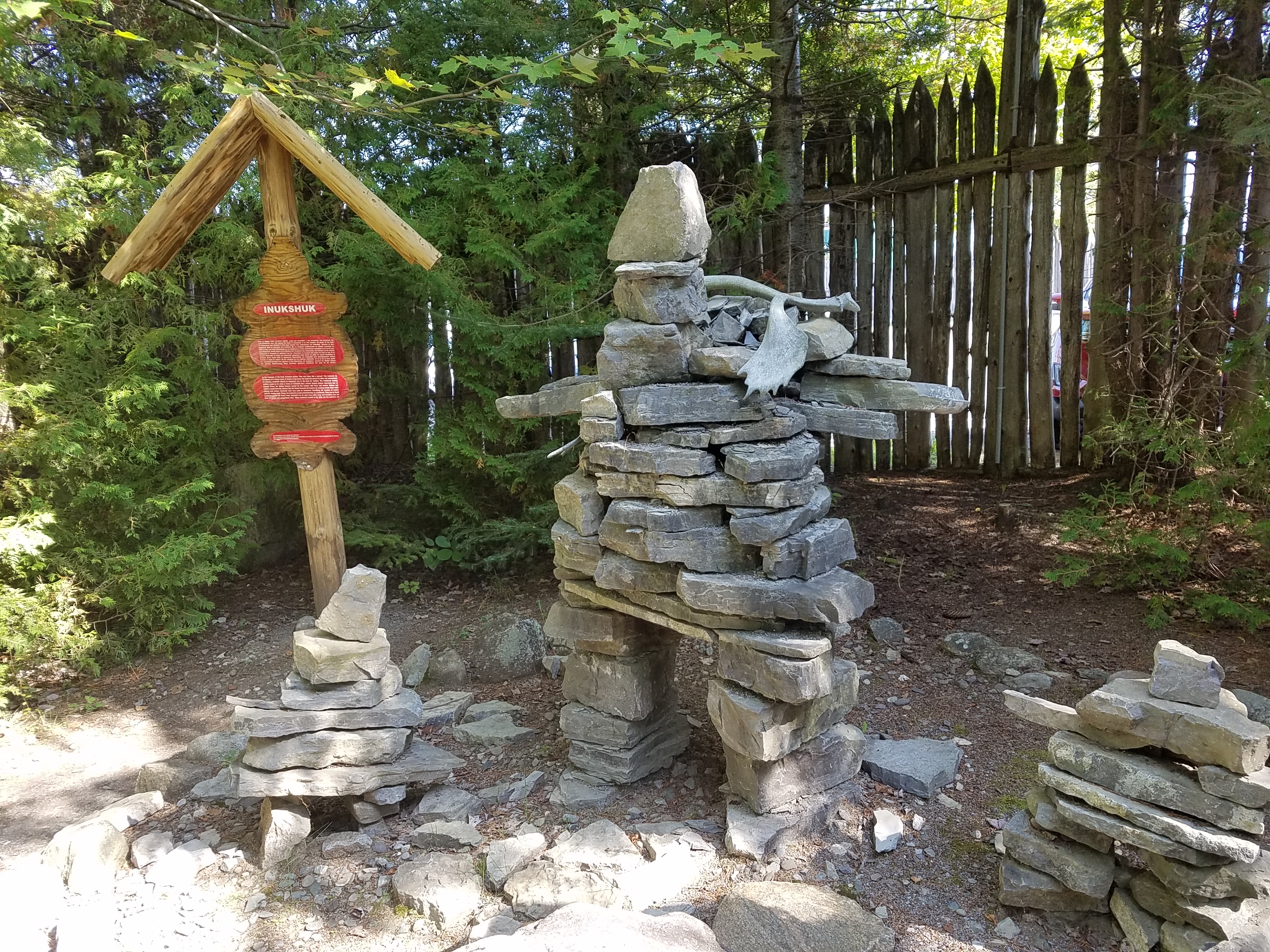 Inukshuks or structures of rough stones stacked in the form of human figures traditionally used by Inuit people as a landmark or a commemorative sign  - at the replica Wendat (Huron) village outside Quebec City.
