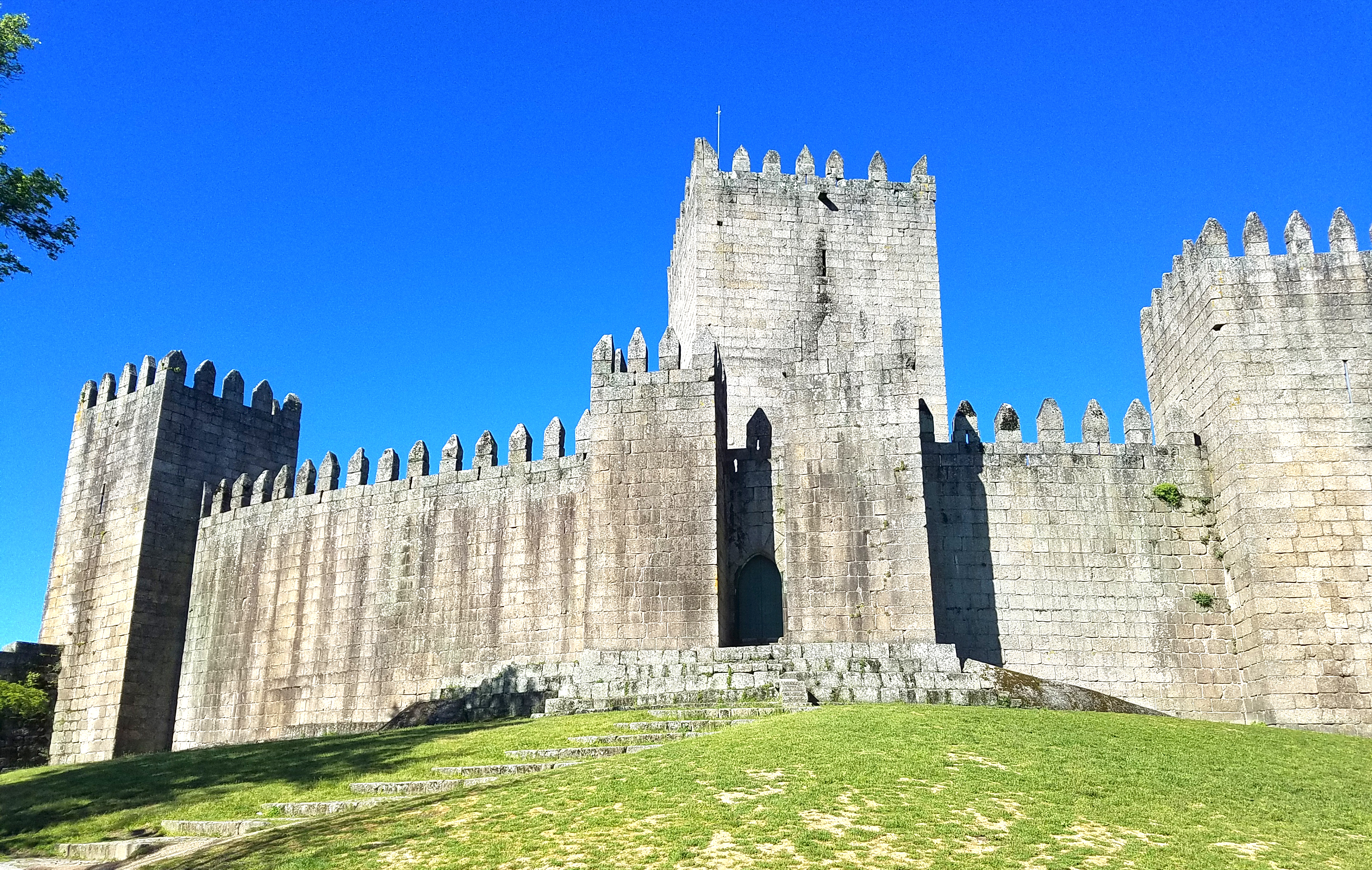 The castle in Guimaraes was built in the 10th century to protect a nearby monastery from Moors and Norsemen.  As the first capital of the nation and birthplace of its first king, Guimaraes it is one of Portugal's most historic cities  and one of the most attractive places to visit in the country. Its historic town center is listed as a World Heritage Site in recognition of its being an "exceptionally well-preserved and authentic example of the evolution of a medieval settlement into a modern town" in Europe. 