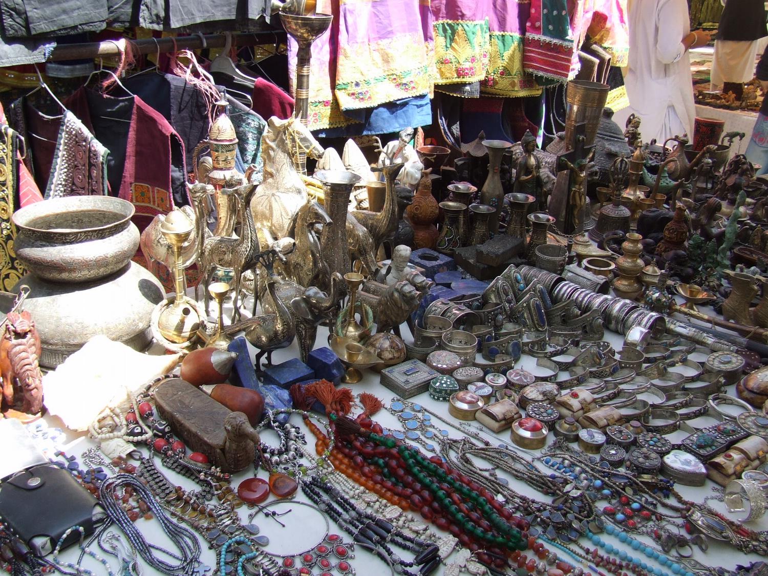 Clothing, jewelry, sculptures, and handicrafts on display at a bazaar in Kabul.
