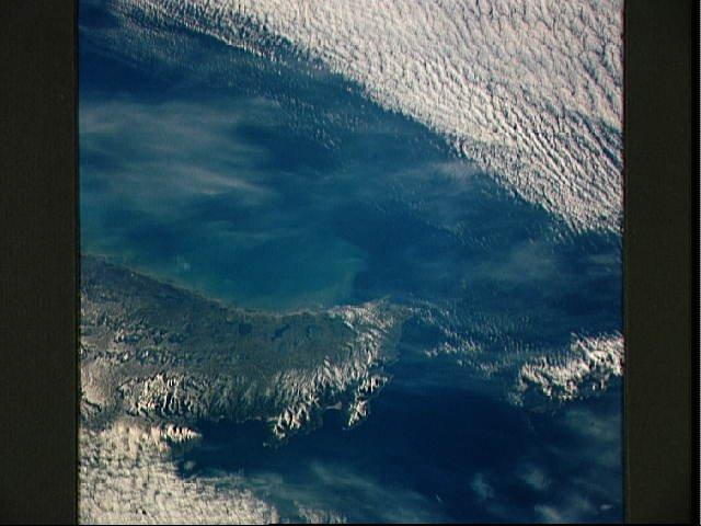 The Mitre Peninsula is the easternmost tip of Tierra del Fuego, Argentina. Early winter snow may be seen on this south tip of the Andes Mountains. These same mountains continue underwater to Antarctica. The Strait of Magellan, separating the South American mainland from Tierra del Fuego, is off the scene to the north and west, but the Strait of Le Maire, separating Tierra del Fuego from the Isla de los Estados may be seen off to the east (right). Image courtesy of NASA.