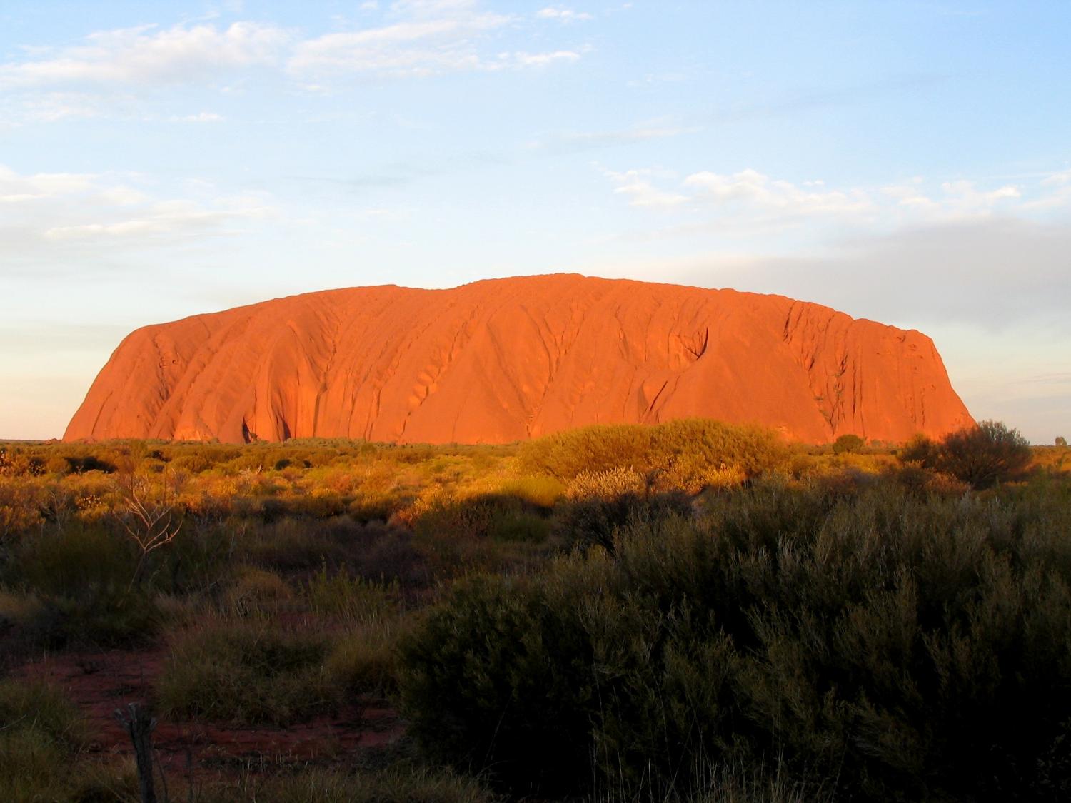 Uluru / Ayers Rock is an inselberg, or island mountain, found in the Northern Territory near Alice Springs - in the middle of Australia's Outback.  It is a large sandstone rock formation that the aborigines of the area hold sacred.  