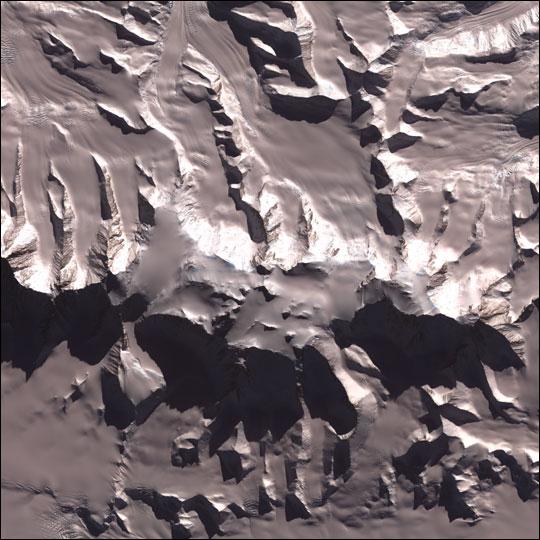 Vinson Massif is the tallest mountain in Antarctica. Its peak reaches 4,897 m (16,067 ft), though the mountain itself is a large raised feature around 21 km (13 mi) long and 13 km (8 mi) wide, dominating the Sentinel Range of the Ellesworth Mountains in which it is located. Image courtesy of NASA.
