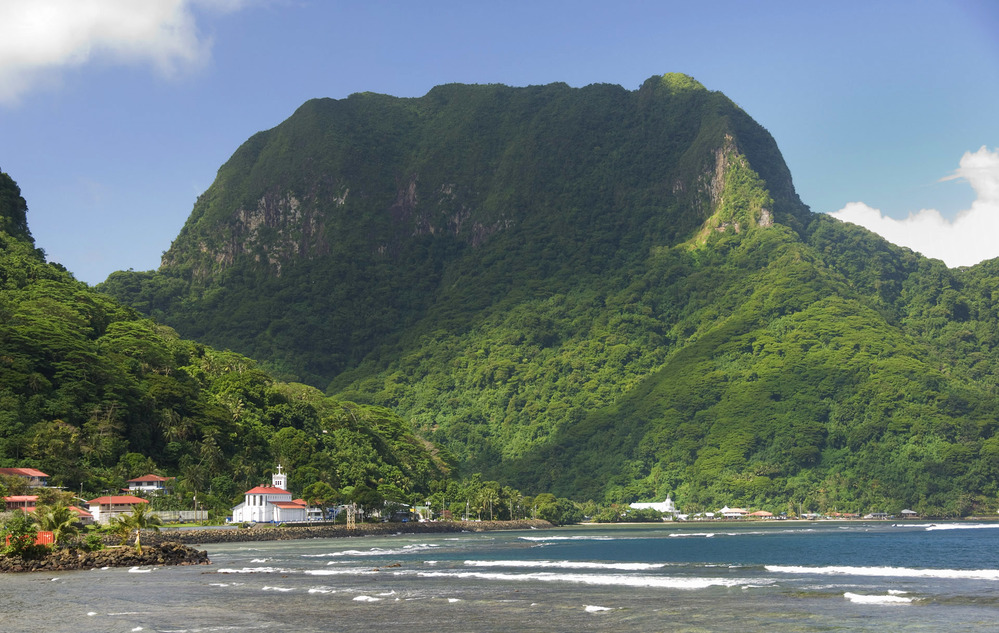 One of the seven National Natural Landmarks located on the opposite side of Pago Pago Harbor, Rainmaker Mountain is a great mass of volcanic rocks extruded as molten magma during major episodes of volcanism that created Tutuila island. Photo courtesy of the US National Park Service.