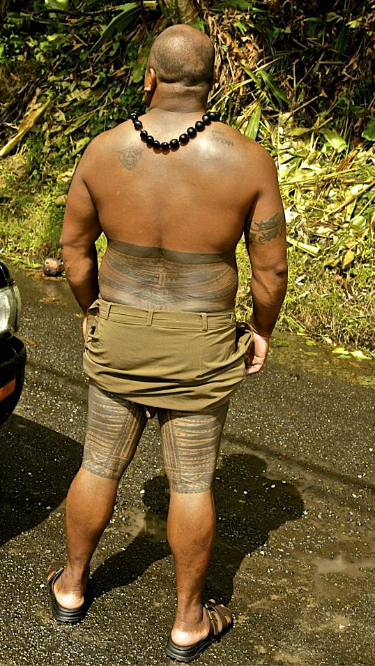 Pe'a is the name of the traditional male tattoo of Samoa. The pe'a covers the body from waist to the knees. The tattoo starts on the back and finishes on the belly button. Overall, the design is symmetrical with a pattern consisting mainly of straight lines and larger blocks of dark cover, usually around the thighs. Photo courtesy of the US National Park Service/ Cathy Johnson.