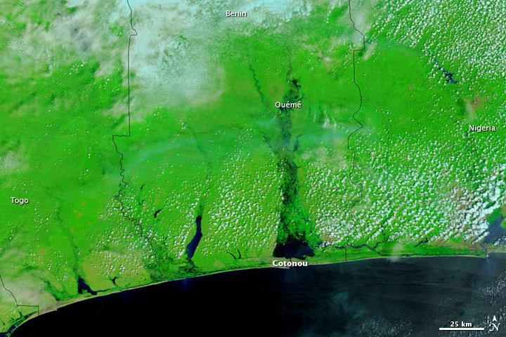 Heavy rains flooded parts of West and Central Africa in the rainy season of 2010, and among the hardest-hit countries was Benin. The image, which shows the coast of Benin on 22 October 2010, uses a combination of infrared and visible light to increase the contrast between water and land. Water ranges in color from electric blue to navy. Vegetation appears bright green. Clouds range in color from off-white to pale blue-green. Photo courtesy of NASA.

