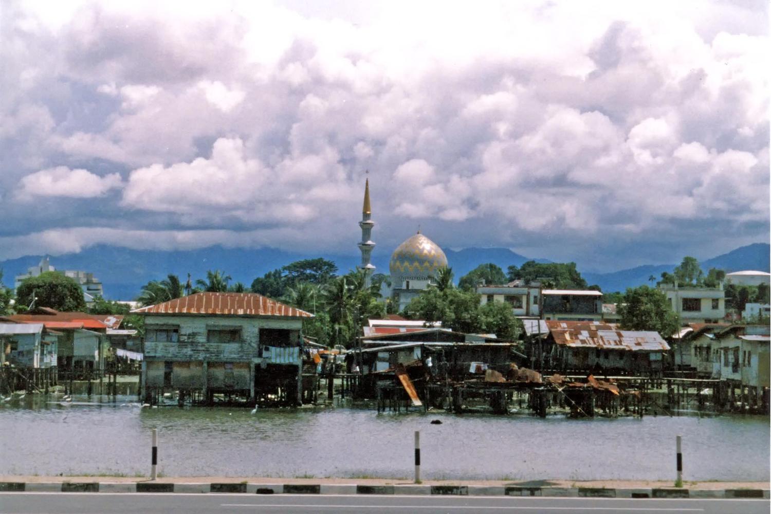 Another view of the water village of Kampong Ayer; the Sultan Omar Ali Saifuddin Mosque looms in the background.