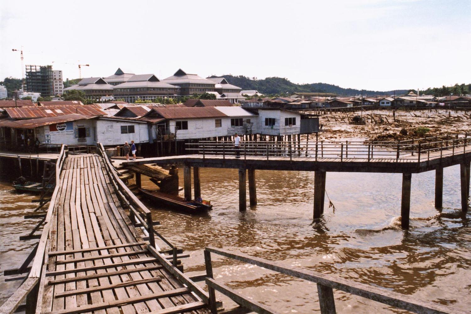 Bandar Seri Begawan is the capital and largest city of the Sultanate of Brunei. The water village of Kampong Ayer lies within its boundaries. The village, whose houses stand on stilts, stretches about 8 km (5 mi) along the Brunei River; it is a self-contained settlement equipped with schools, police stations, clinics, a waterborne fire brigade, and mosques - all connected by walkways and bridges. 