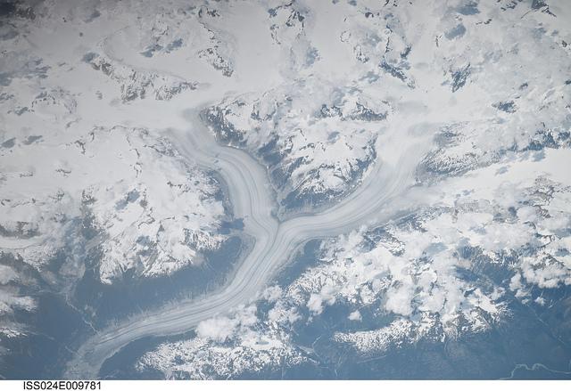 The snow-covered Coastal Mountains of British Columbia are featured in this image taken from the International Space Station. The long smooth areas are glaciers. Photo courtesy of NASA.
