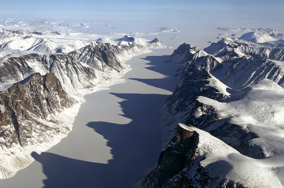 The image captures an ice covered fjord on Baffin Island with Davis Strait in the background. Image Credit: NASA/Michael Studinger.
