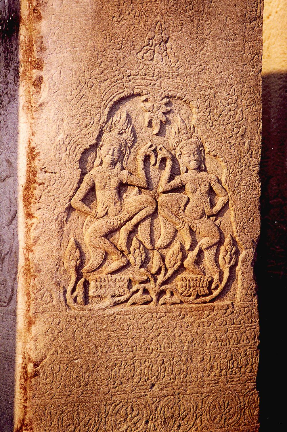 Carving at Banteay Srei, a 10th century red sandstone temple at Angkor that is much smaller than the other temple complexes in the region. Many of the exquisite carvings in this temple were stolen and sent to museums around the world. Today, some of these carvings have been replaced by cement replicas.