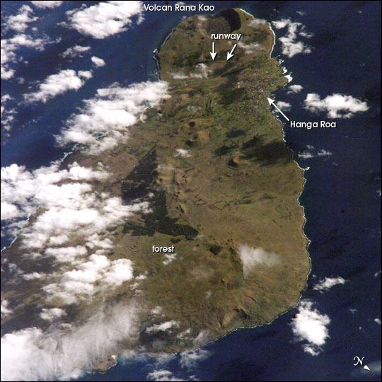 View of Easter Island from space. The  island is one of the most remote locations on Earth, being more than 3,200 km (2,000 mi) from the closest populations on Tahiti or Chile. The island is perhaps most famous for the giant stone monoliths, known as moai, that have been placed along the coastline. Archaeologists believe the island was discovered and colonized by Polynesians sometime between A.D. 400 and 700. Subsequently, a unique culture developed. The human population grew to levels that could not be sustained by the island. A civil war resulted, and the island's deforestation and ecosystem collapse was nearly complete. Today, a new forest (primarily eucalyptus) has been established in the center of the island (dark green). Less than 25 km (15 mi) long, the geography of the island is dominated by volcanic landforms, including the large crater Rana Kao at the southwest end of the island and a line of cinder cones that stretch north from the central mountain. A final feature (difficult to see) is the very long runway (Chile's longest) near Rana Kao, which served (but was never used) as an emergency landing site for the Space Shuttle. Image courtesy of NASA.