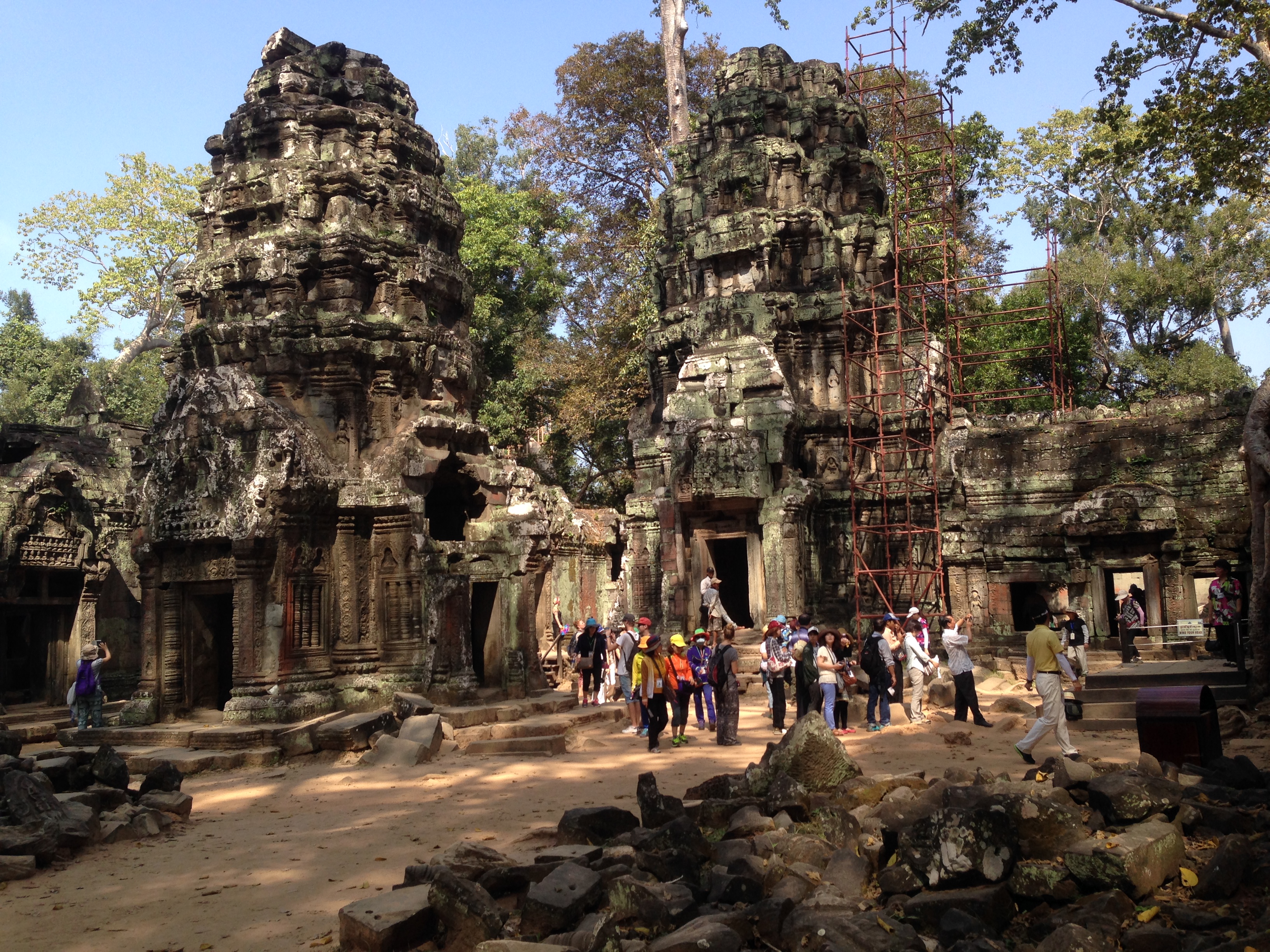 Ta Prohm is the modern name of the temple in Siem Reap, built largely in the late 12th and early 13th centuries. Located approximately 1 km east of Angkor Thom, it was founded by the Khmer King Jayavarman VII as a Buddhist monastery and university. Unlike most Angkorian temples, Ta Prohm remains in much the same condition as when it was found. The photogenic and atmospheric combination of trees growing out of the ruins and the jungle surroundings have made it one of Angkor's most popular temples with visitors. UNESCO inscribed Ta Prohm on its World Heritage List in 1992. Today, it is one of the most visited complexes in Cambodia’s Angkor region.