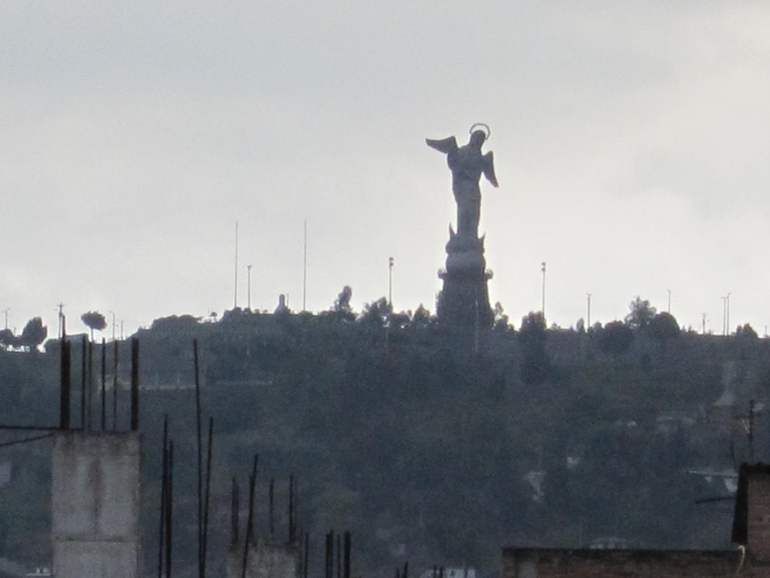 The Virgin of the Apocalypse statue overlooking historic Quito from El Panecillo hill. 