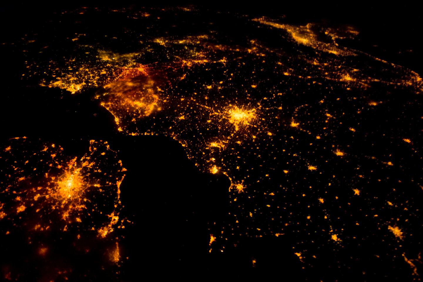 Several of the oldest cities of northwestern Europe are highlighted in this astronaut photo of 10 August 2011. While the landscape is dotted with clusters of lights from individual urban areas, the metropolitan areas of London (lower left), Paris (center), Brussels, and Amsterdam (upper left) stand out due to their large light "footprints." The metropolitan area of Milan is also visible at image upper right. While each of these cities is, or has been, the capital of a kingdom, republic, or empire - Paris and London have been all three - Brussels is also the capital city of the European Union. To give a sense of scale, the centers of the London and Paris metropolitan areas are approximately 340 km (210 mi) from each other. The image is also oblique making the distance between Paris and Milan (640 km, or 400 mi) appear less than that of Paris to London. In contrast to the land surface defined by the city lights, the English Channel presents a uniform dark appearance. Similarly, the Alps near Milan are also largely devoid of lights. While much of the atmosphere was clear at the time the image was taken, the lights of Brussels are dimmed by thin cloud cover. Image courtesy of NASA.

