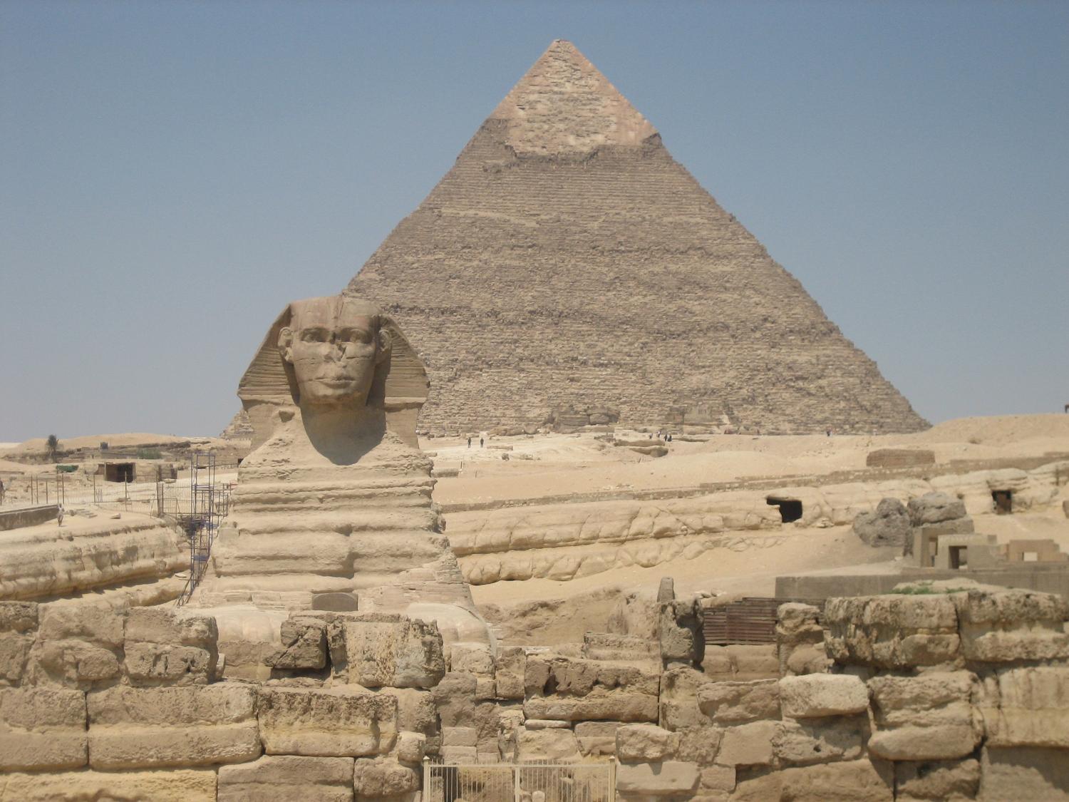 The Sphinx and the Pyramid of Khafre at Giza. Unlike the pyramids, the Sphinx was not assembled piece by piece, but was carved from a single mass of limestone.