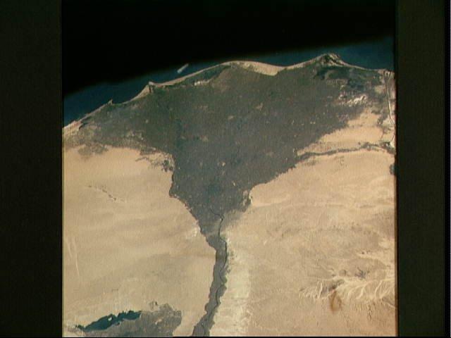 The Nile Delta of Egypt, irrigated by the Nile River and its many distributaries, is some of the richest farm land in the world and home to over half of Egypt's population. The capital city of Cairo lies at the apex of the delta in the middle of the scene. Across the river from Cairo one can see the three large pyramids and sphinx at Giza. The Suez Canal is just to the right of the delta; the Mediterranean Sea is at the top of the view. Click on photo for higher resolution. Image courtesy of NASA. 
