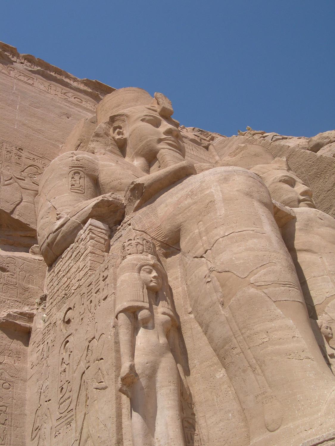 A closer view of one of the statues of Ramses at Abu Simbel shows Nefertari, his wife, at his knee.