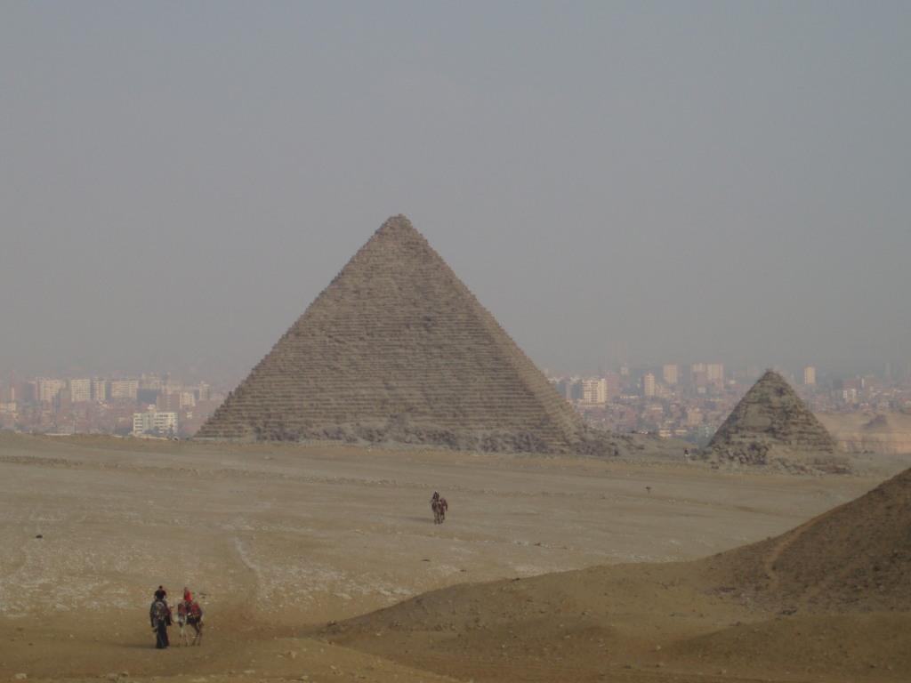 The Pyramid of Menkaure is the smallest of the three kings' pyramids on the Giza Plateau. The city of Cairo appears in the background.

