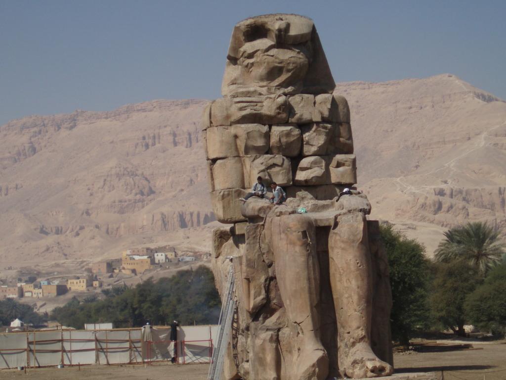 One of a pair of 30-meter (50-ft) statues of Amenhotep III that once stood before the pharaoh's mortuary temple in the Theban Necropolis on the west bank of the Nile opposite Luxor. The rest of the temple was dismantled, and the materials used for other construction projects. The statues were called the "Colossi of Memnom" by Egypt&amp;apos;s late Ptolemaic (Greek) rulers who associated them with the myth of Memnon.