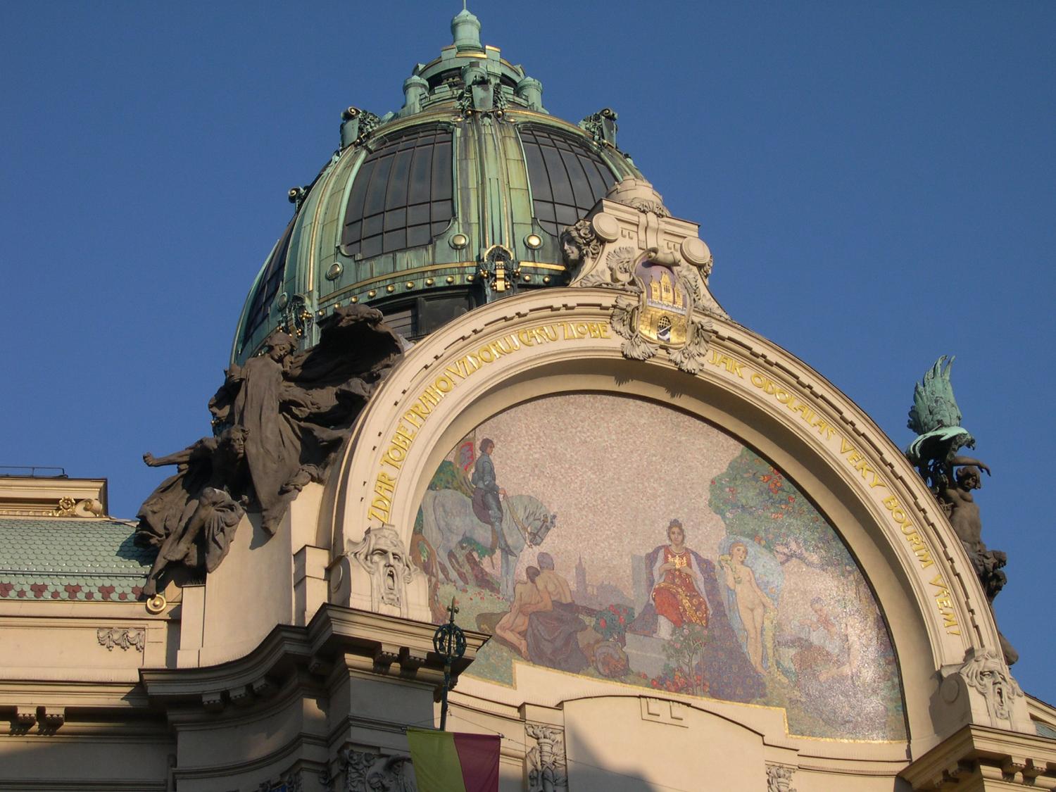 The Municipal House (Obecni Dum) is a national cultural landmark and the premier Art Noveau building in Prague. Opened in 1912 on Republic Square, it houses a concert hall and an elegant French restaurant. Shown is the large exedra under the main cupola of the building with its colorful glass mosaic depicting The Apotheosis of Prague. 
