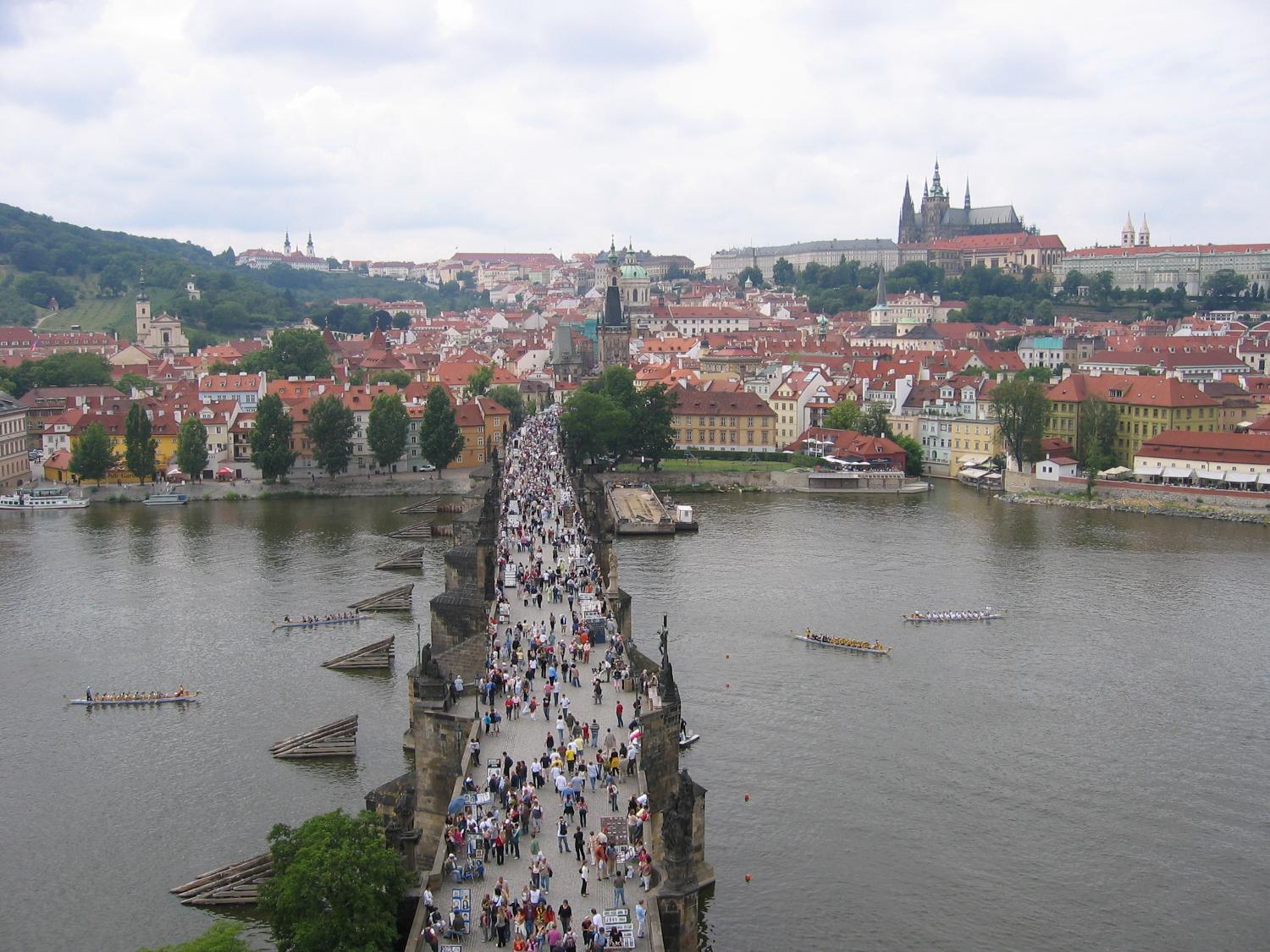 The bustling, pedestrian-friendly Charles Bridge as viewed from the tower on the Stare Mesto (Old Town) side of the structure. The bridge is 516 m long and almost 10 m wide and rests on 16 arches shielded by ice guards. Thirty statues of saints decorate the bridge avenue; most were originally erected between 1683 and 1714, but then replaced with replicas beginning in 1965. The originals are currently housed in the National Museum. 