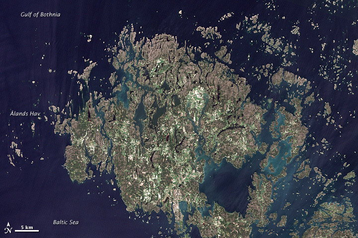 The Åland Islands (pronounced O-lahnd) lie at the southern end of the Gulf of Bothnia, between Sweden and Finland. The archipelago consists of several large islands and roughly 6,500 small isles, many of them too small for human habitation.
Åland vegetation is a combination of pine and deciduous forest, meadows, and farmed fields. 
Image courtesy of NASA/Jesse Allen & Robert Simmon, using USGS Landsat data.
