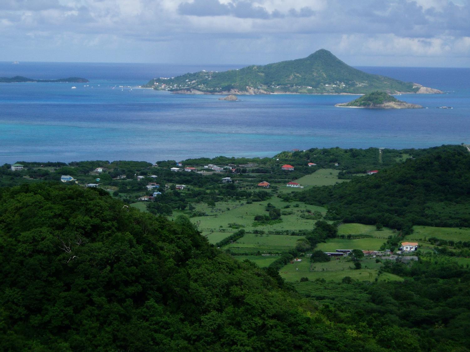 Photo taken from the island of Carriacau, part of Grenada. The island visible on the horizon is Petit Martinique, also part of Grenadan territory.