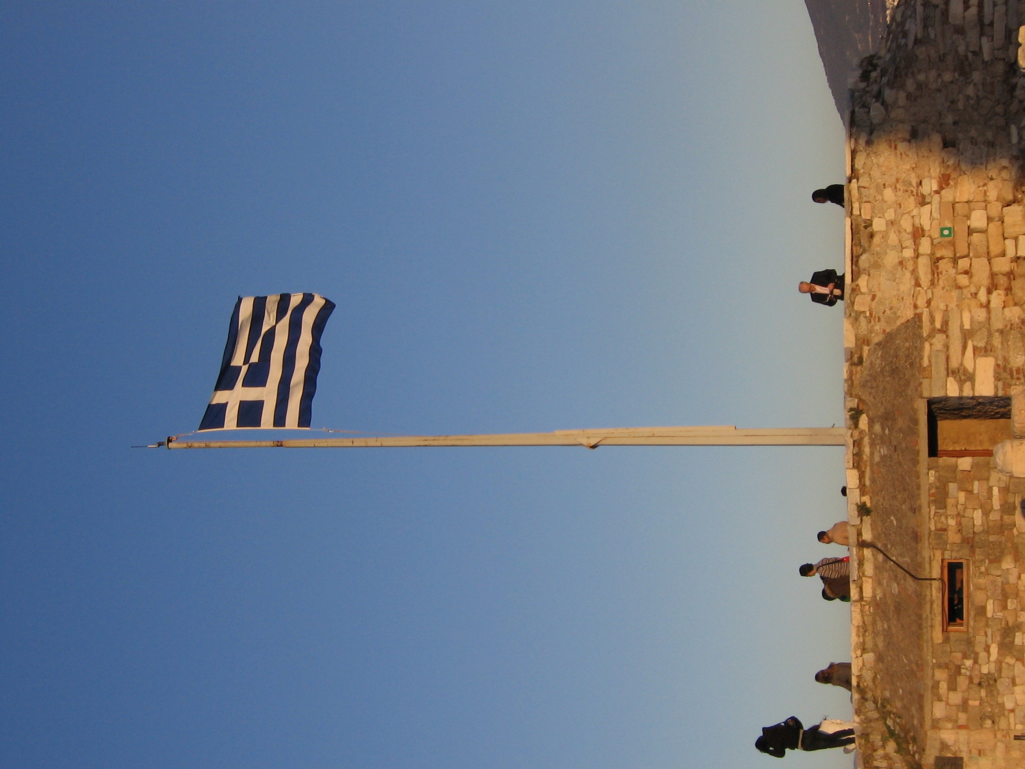 The Greek flag flies over the Acropolis.