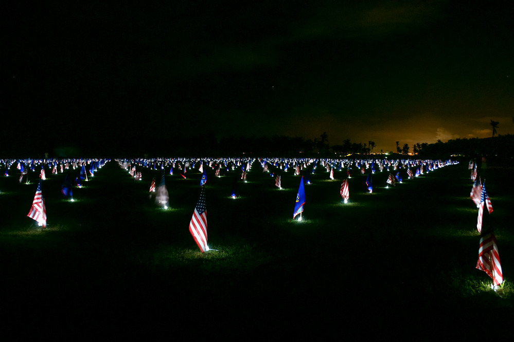 A nighttime display of flags during a Memorial Day flag event. The alternating flags are those of the United States and Guam. Photo courtesy of the US National Park Service.