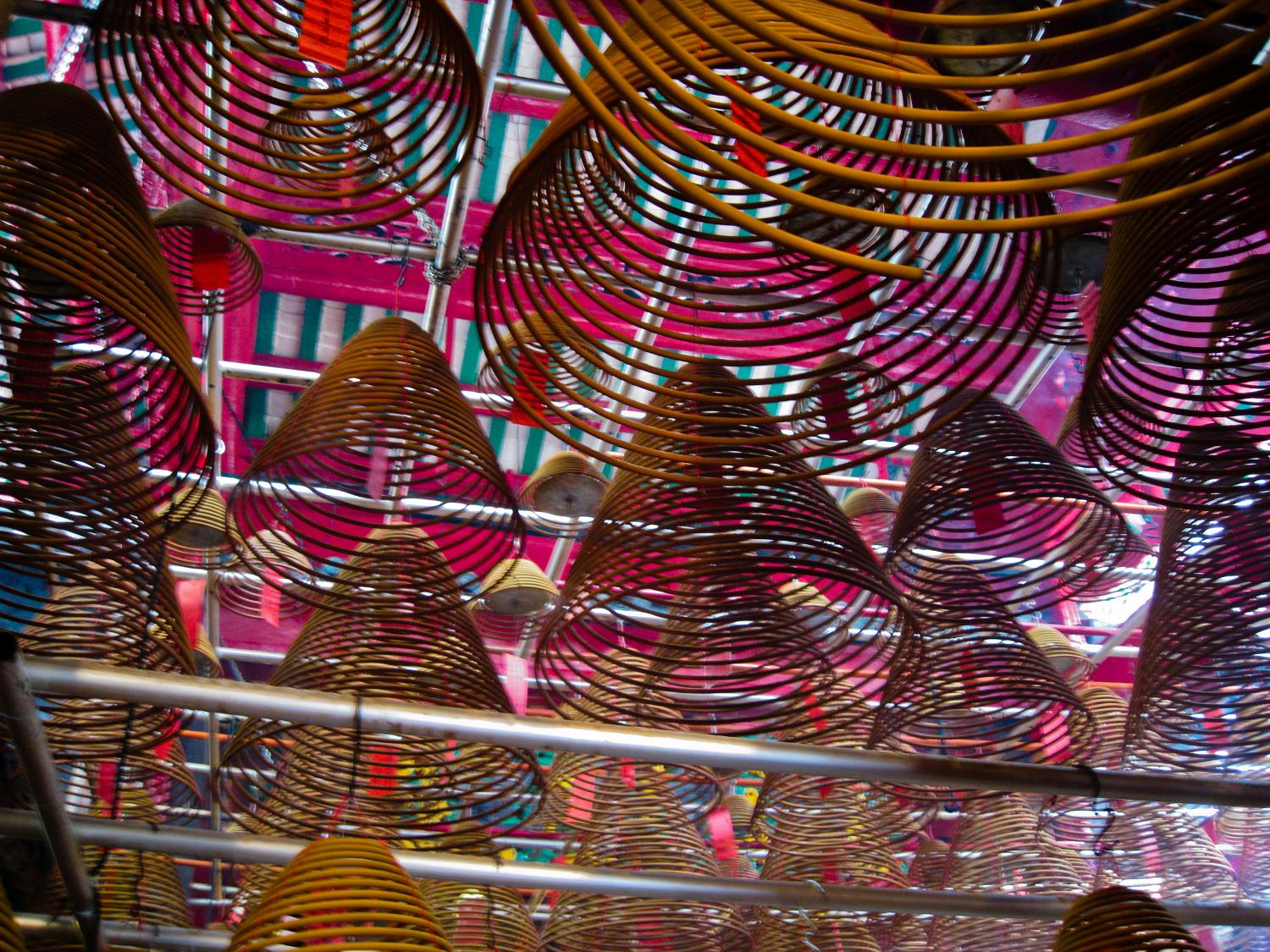 Huge incense coils hang from the ceiling of the Man Mo Temple in Hong Kong, one of the oldest and most famous temples in the city.  