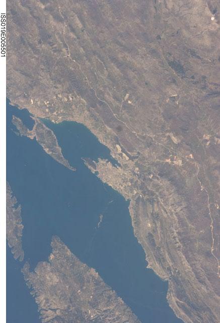 This view features the Dalmatian coastline of Croatia around the city of Split. Much of the region can be characterized by northwest-southeast oriented linear islands and embayments of the Adriatic Sea. This distinctive coastal geomorphology is the result of faulting caused by tectonic activity in the region and sea level rise. Photo courtesy of NASA.