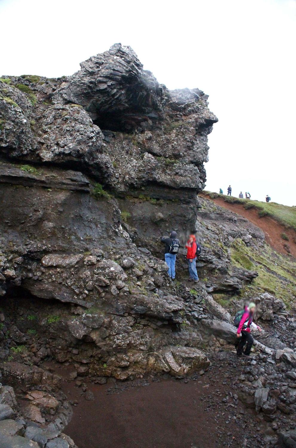 A dike (volcanic feeder tube) merging into layered strata in Thingvellir National Park.  