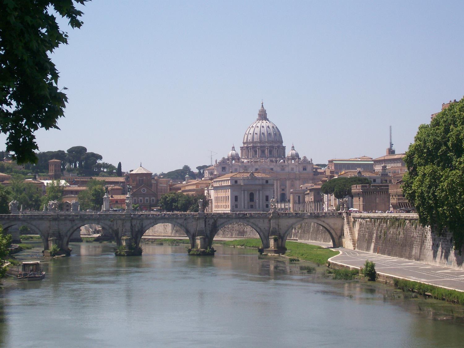 The Vittorio Emanuele Bridge over the Tiber River in Rome with Vatican City in the background. The bridge was completed in 1911. 