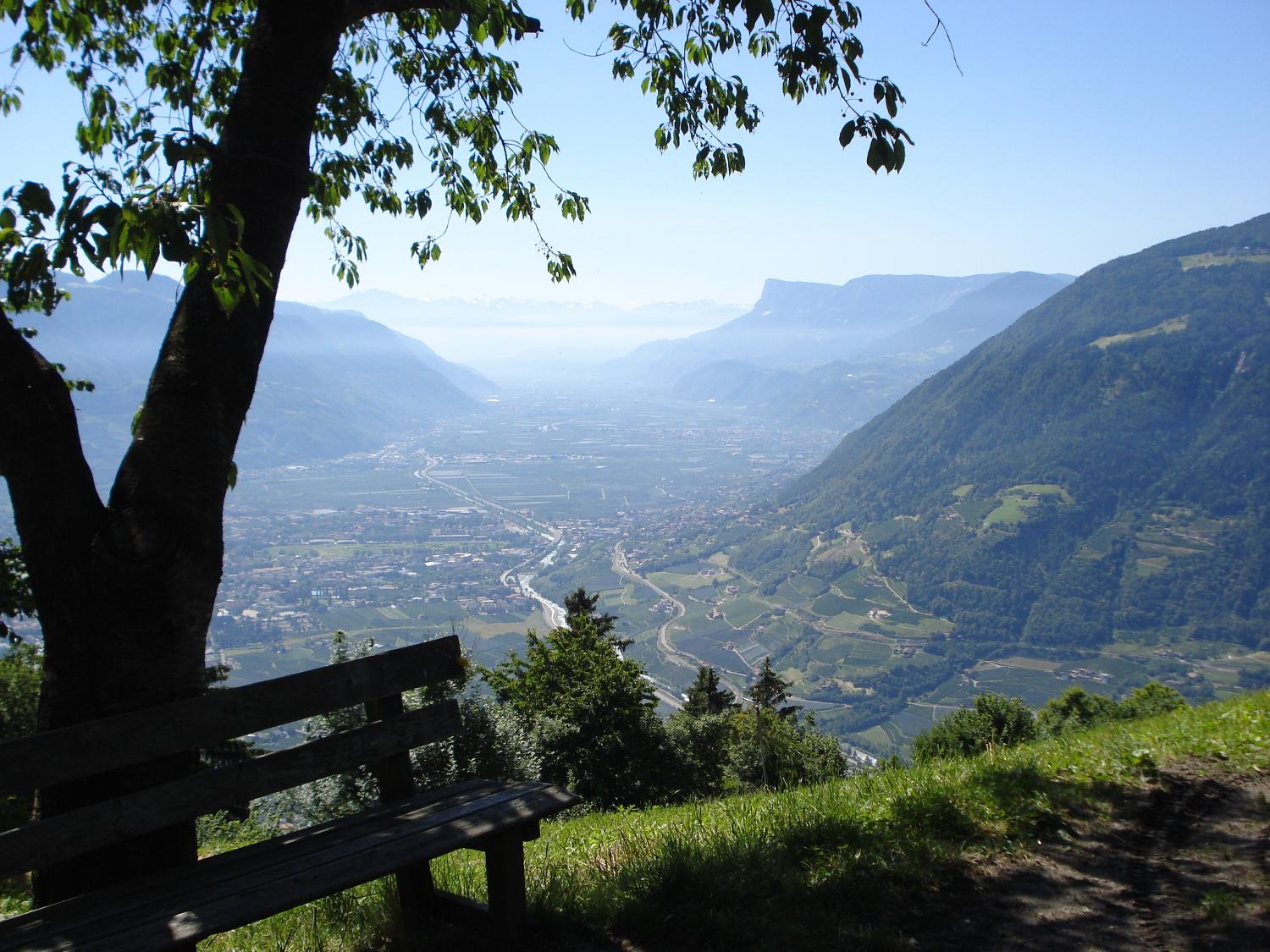 A scenic view of the town of Meran nestled in the mountains.