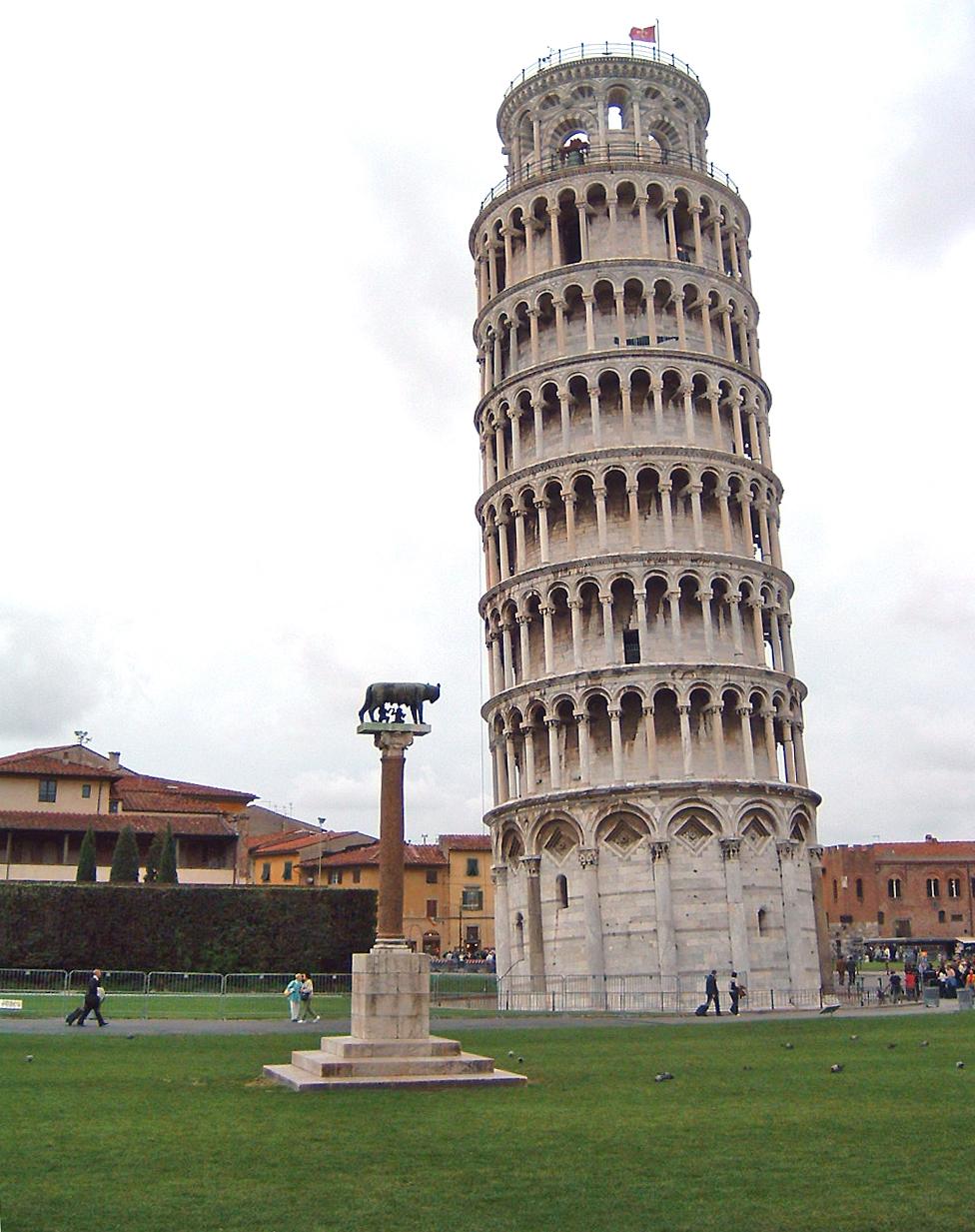 The famous Leaning Tower at Pisa. A statue of the legendary founders of Rome, Romulus and Remus, being suckled by a she-wolf appears in the foreground. 