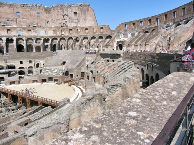 The Roman Colosseum's arena was a wooden floor covered with sand, underlain with rooms and passageways for performers, sets, and animals. Spectator seating was divided into three sections: ordinary people sat in the upper level, the better off in the middle sections, and the elite in the lower level. 