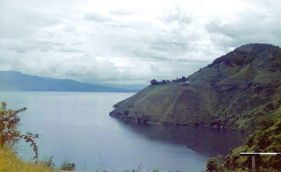 Lake Toba is located in the middle of the northern part of the island of Sumatra, occupying the caldera of a supervolcano. The lake is about 100 km (62 mi) long, 30 km (19 mi) wide, and up to 505 m (1,657 ft) deep. It is the largest lake in Indonesia and the largest volcanic lake in the world. 
Lake Toba is the site of a supervolcanic eruption estimated at a Volcanic Explosivity Index (VEI) of 8, the largest recorded value on the index. Recent advances in dating methods suggest the date was 74,000 years ago and that it represented a climate-changing event. It is the largest-known explosive eruption on earth in the last 25 million years. 

