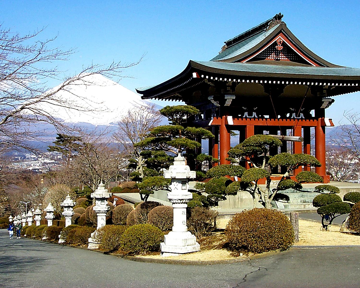 The temple gable mimics the shape of Mt. Fuji in the background. 