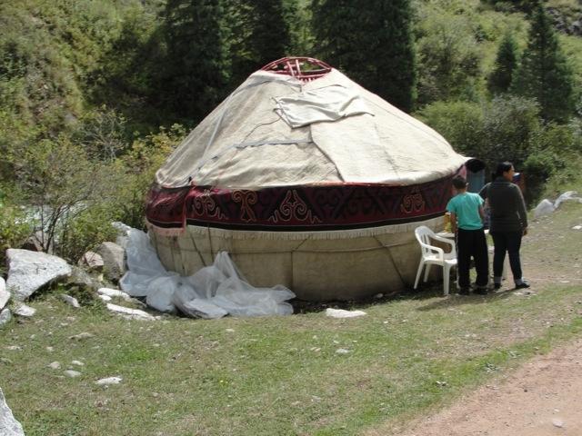 A typical Kyrgyz yurt, a portable, bent-wood framed shelter covered by layers of fabric, typically felt.  