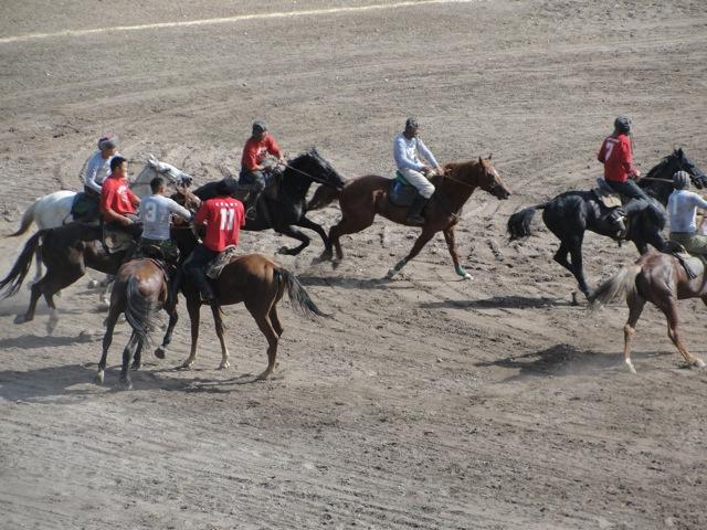 The national game of Kyrgyzstan, Ulak Tartush, is a version of polo played with a headless goat. Note that some of the riders wear old Soviet tank helmets for head protection.
