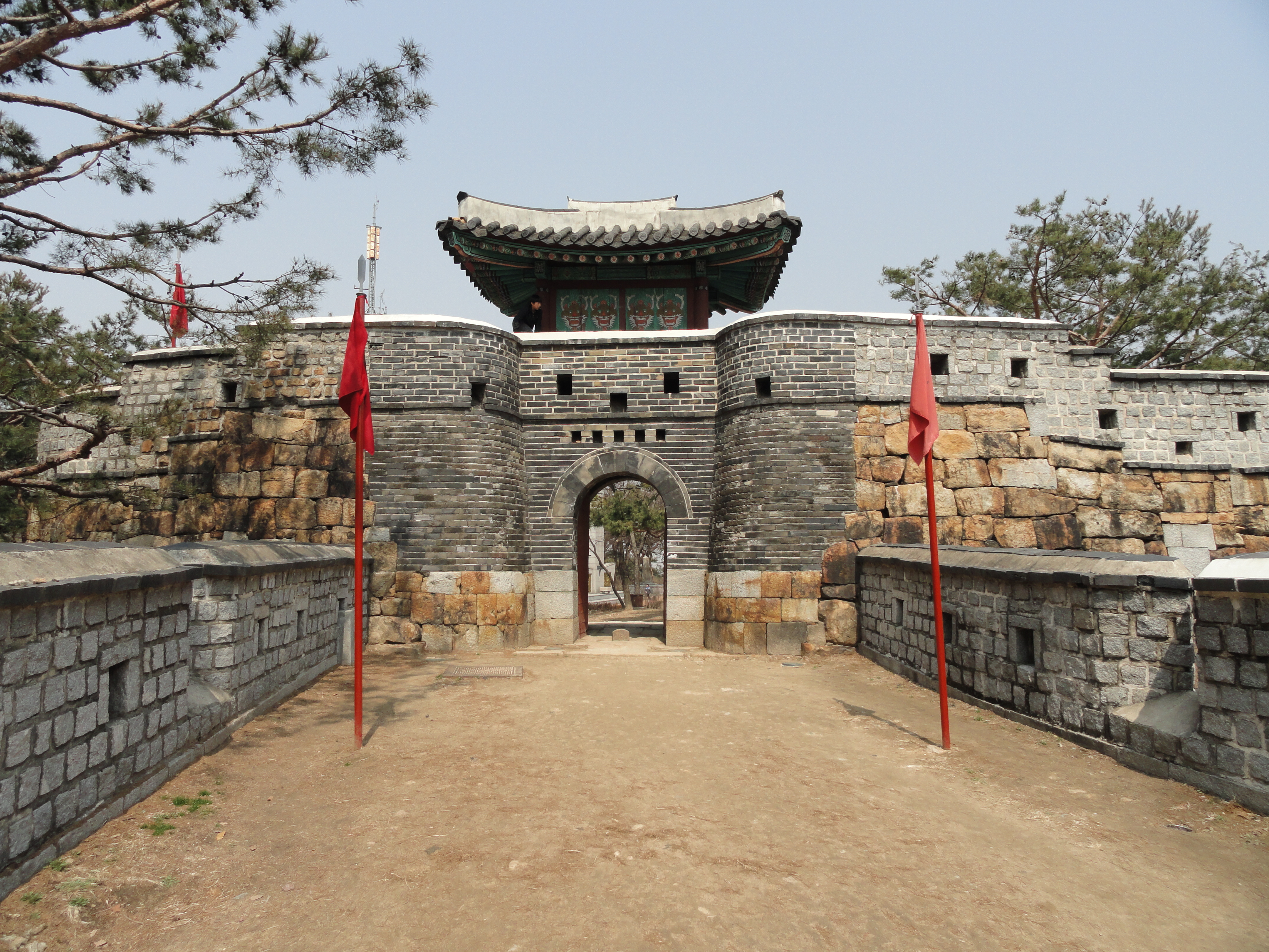 The entrance to Hwaseong Fortress or Suwon Hwaseong. Built between 1794 and 1796, the fortification surrounds the center of Suwon, the provincial capital of Gyeonggi-do, in South Korea. Located 30 km (19 mi) south of Seoul and enclosing much of central Suwon, the fortress includes a palace, Haenggung. The fortress and enclosed palace were designated as a World Heritage site by UNESCO in 1997.