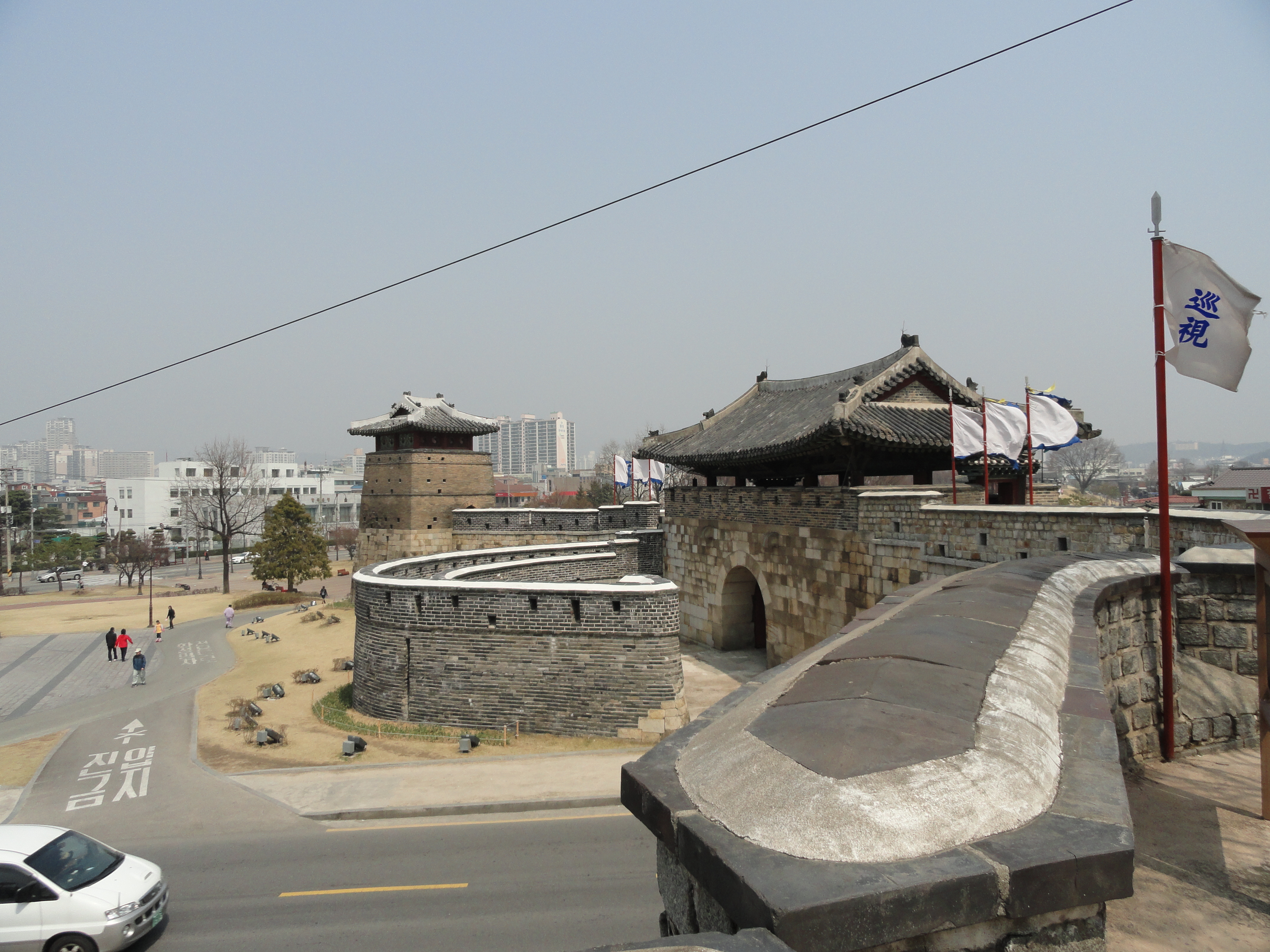 View of some of the outer walls at Hwaseong Fortress or Suwon Hwaseong. Built between 1794 and 1796, the fortification surrounds the center of Suwon, the provincial capital of Gyeonggi-do, in South Korea. Located 30 km (19 mi) south of Seoul and enclosing much of central Suwon, the fortress includes a palace, Haenggung. The fortress and enclosed palace were designated as a World Heritage site by UNESCO in 1997.