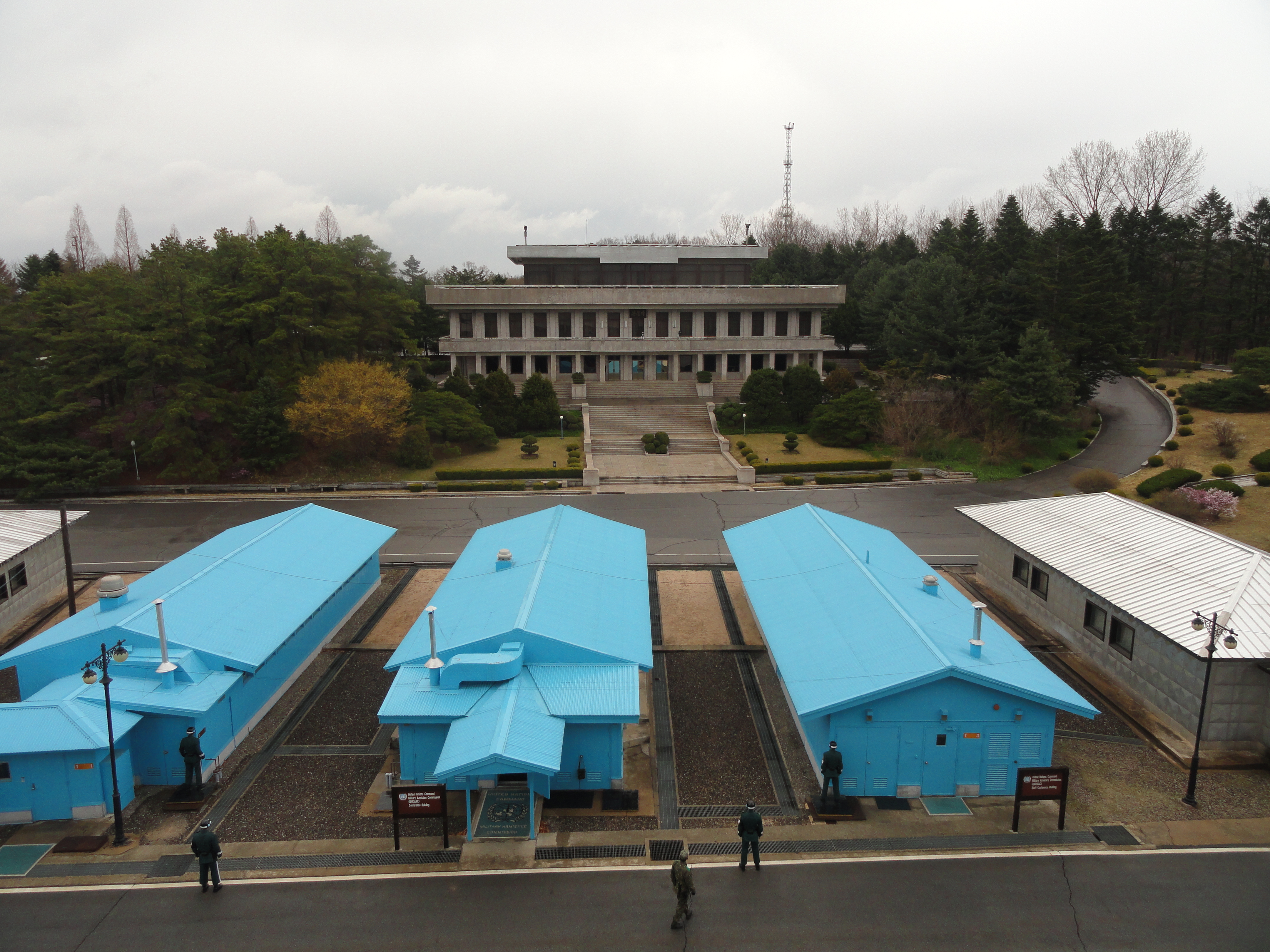 The Joint Security Area (JSA, often referred to as the Truce Village or Panmunjom) is the only portion of the Korean Demilitarized Zone (DMZ) where North and South Korean forces stood face-to-face. In 2018, North and South Korean officials agreed to clear the JSA of all landmines, weapons, and guard posts. This withdrawal was completed on 25 October 2018 and the JSA now contains just 35 unarmed security guards. The area is slated to mainly become a tourist attraction.

The photo shows South Korean soldiers standing guard at the JSA between the blue UN buildings. The white buildings are North Korean. This view is from the House of Freedom in South Korea looking towards the three-story Panmungak Hall in North Korea. 

