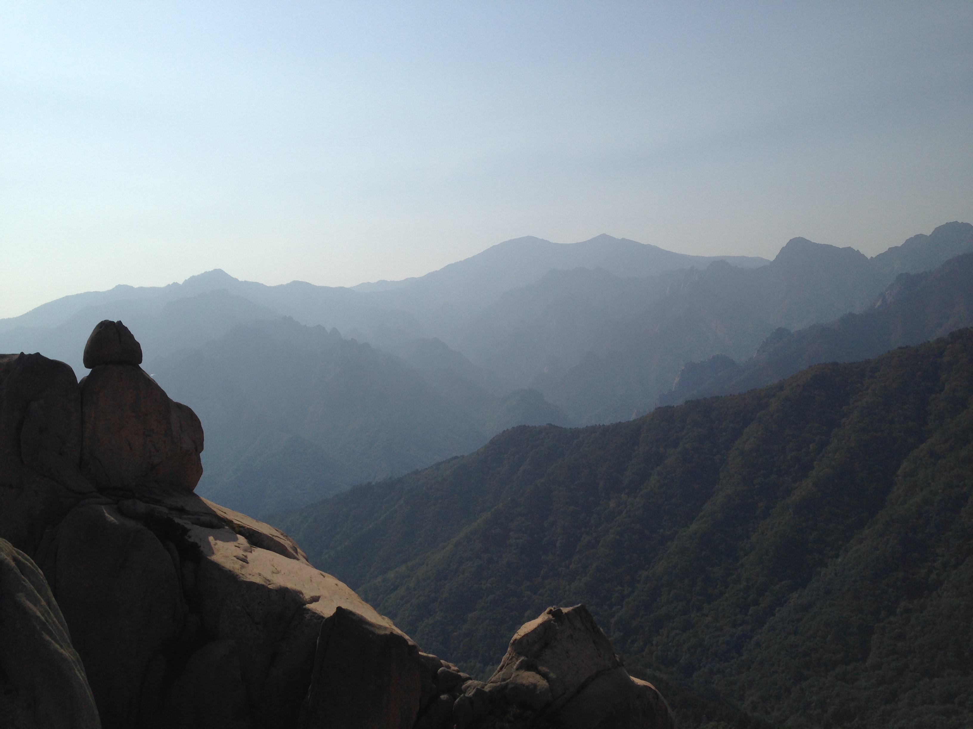 This photo is a view from the trail that ascends to the main peak, Daecheongbong. The stone formation on the left in Seorak National Park resembles a seated person looking out on the valley and meditating.