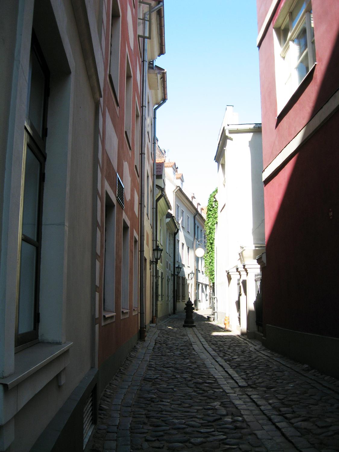 Morning sunlight illuminates a clean swept alley way in Riga. 