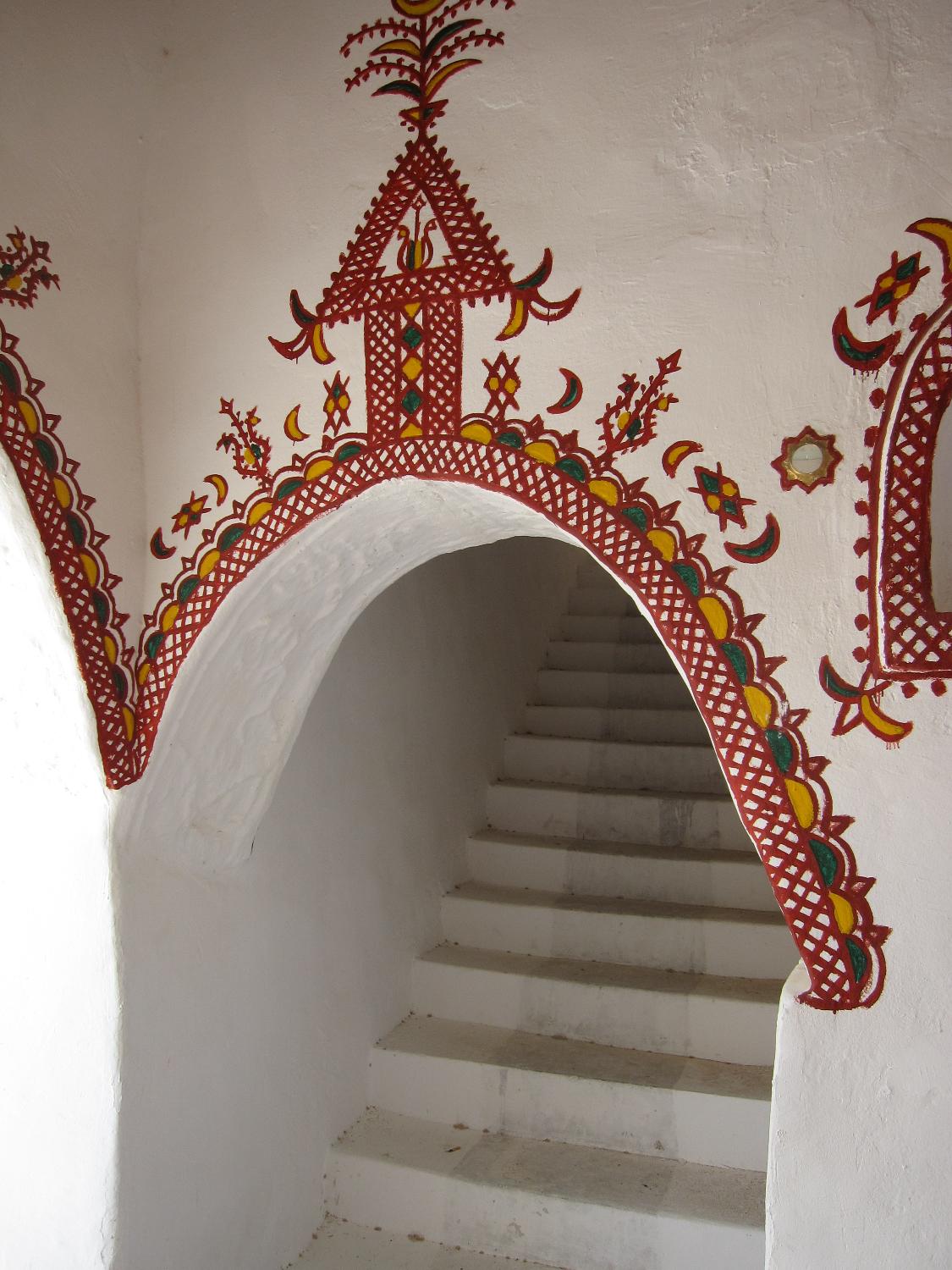 The traditionally decorated mud brick architecture of Ghadames' Old City is designed for natural cooling.  Buildings are built directly adjacent to each other, which insulates the streets and living spaces below from the beating sun.