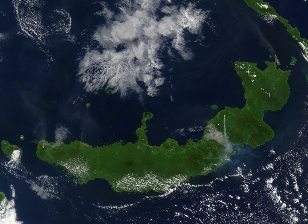 NASA's Terra satellite captured this image of "the troublesome trio" on Papua New Guinea's New Britain island when they erupted simultaneously on 9 August 2005. Langila, Ulawun, and Rabaul Volcanoes all spewed ash at the same time, though not all with the same results. The westernmost volcano, Langila, and the easternmost volcano, Rabaul, sent fairly faint plumes of ash into the air, both of which drifted toward the northwest. Ulawun, the most active volcano in this picture, spit out a dense stream of ash that flew straight south. The volcanoes' proximity to each other and propensity for acting up at the same time suggest that they could be affected by the same tectonic activity underground. Photo courtesy of NASA.