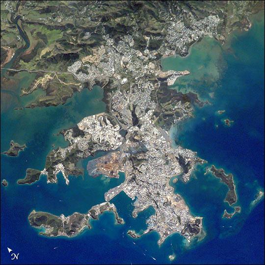 This image shows details of New Caledonia's main city, Noumea, which is built on a peninsula that juts into the lagoon on the southwest side of the island. The reefs here face problems from pollution and overfishing. The tourism industry is very important to the economy of Noumea, with extensive hotel development in the city and along the southeast coast of New Caledonia Island. The picture shows how urban development extends to the steep slopes of the coastal hills. Image courtesy of NASA.