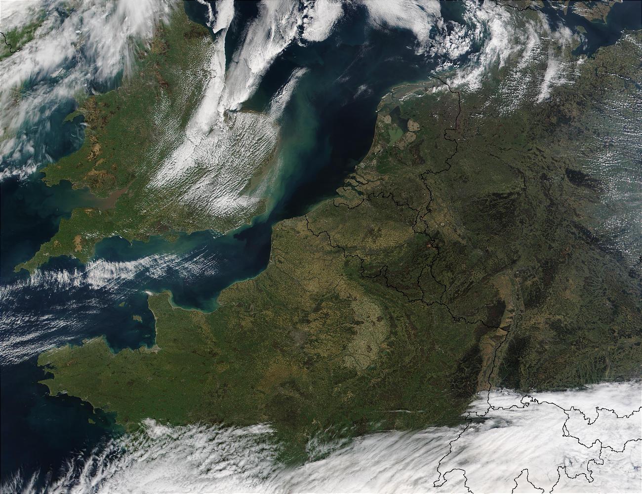 This satellite photo shows Northwest Europe. Visible are the Republic of Ireland (top leftmost), the United Kingdom (top left), France (middle left), Belgium (middle), the Netherlands (top middle), Germany (right), Denmark (top right), Luxembourg (between France, Germany, and Belgium), Switzerland (bottom middle), Italy (bottom middle), and Austria (bottom right); the latter three all cloud covered. Image courtesy of NASA. 