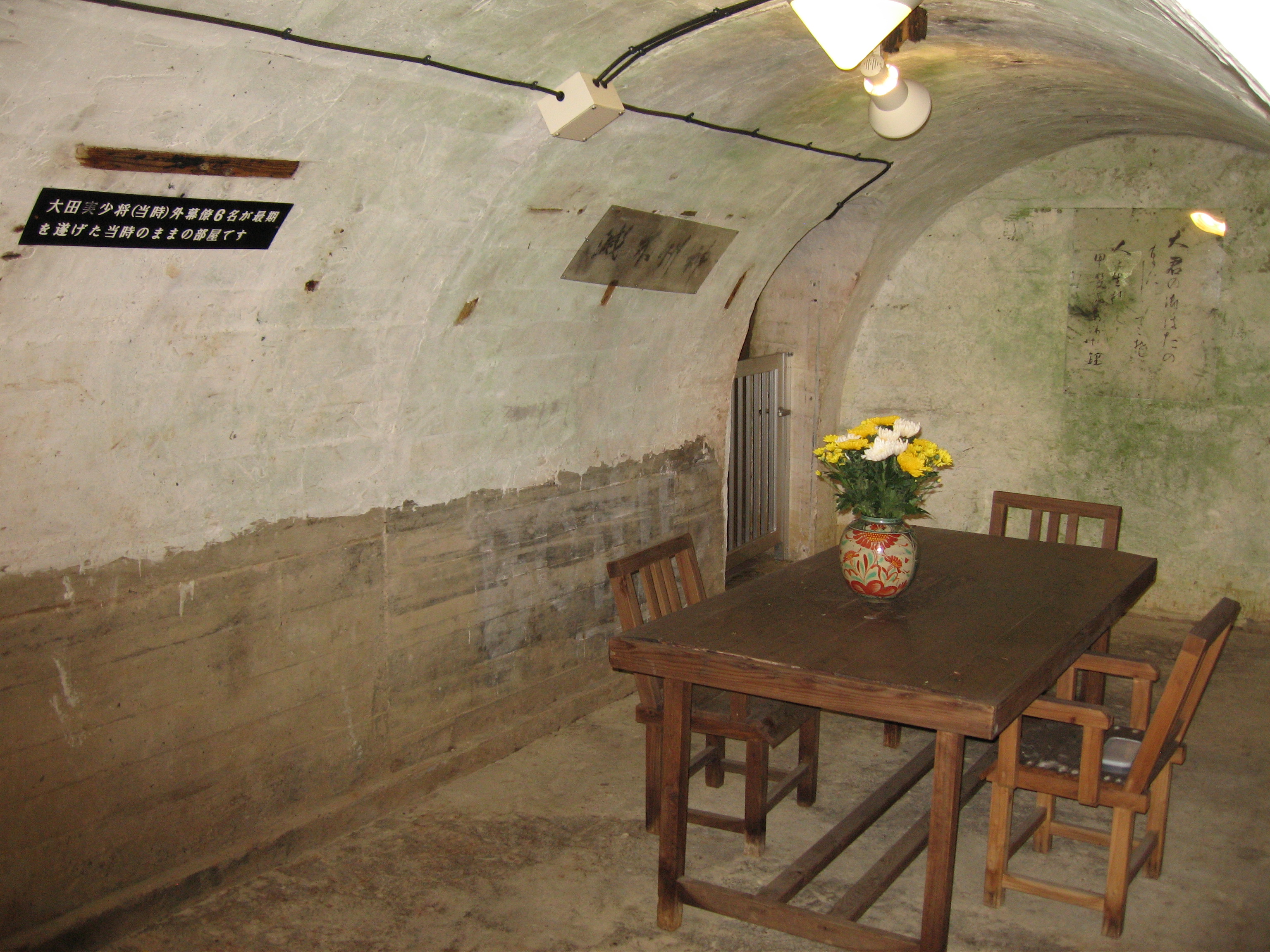 Commanding officer’s room in the Former Japanese Navy Underground Headquarters in Tomigusuku-city. On the surface of a wall of this room, the farewell poem of commanding officer Ota is still brightly visible: “Born as a man, nothing fulfills me more than to die under the banner of the Emperor.”